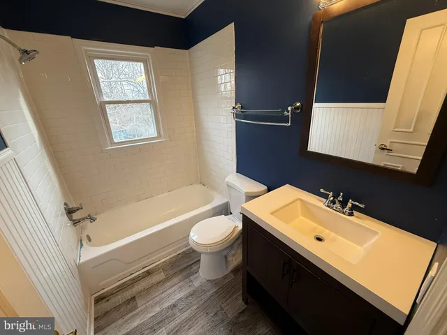 a bathroom with a sink a toilet and bathtub