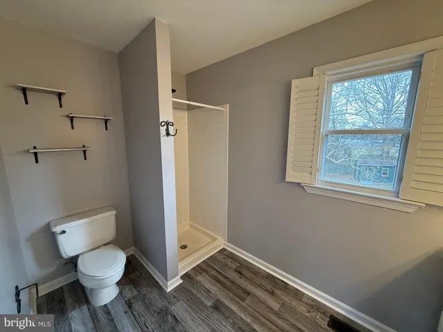 a bathroom with a toilet and a shower