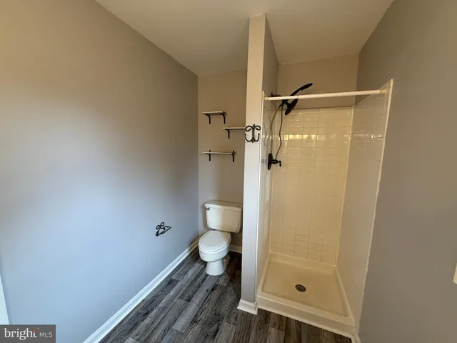 a bathroom with a granite countertop shower toilet and sink