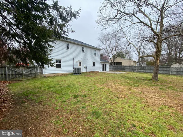 a view of a house with a yard and trees