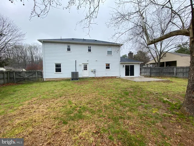 a large tree in front of a house with yard
