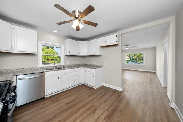 a kitchen with a wooden floor and window