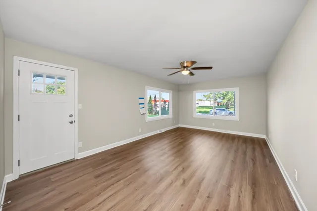 wooden floor in an empty room with a window