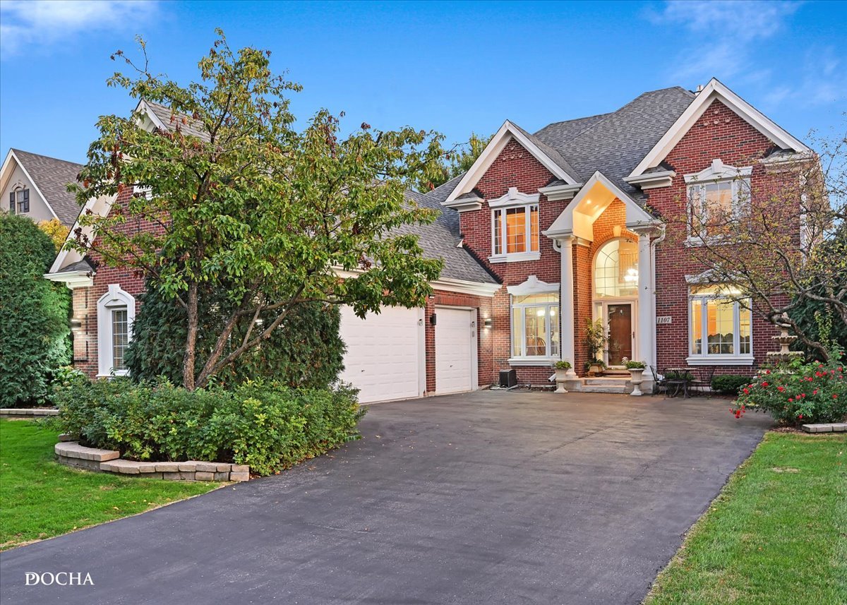 a front view of a house with a yard and garage