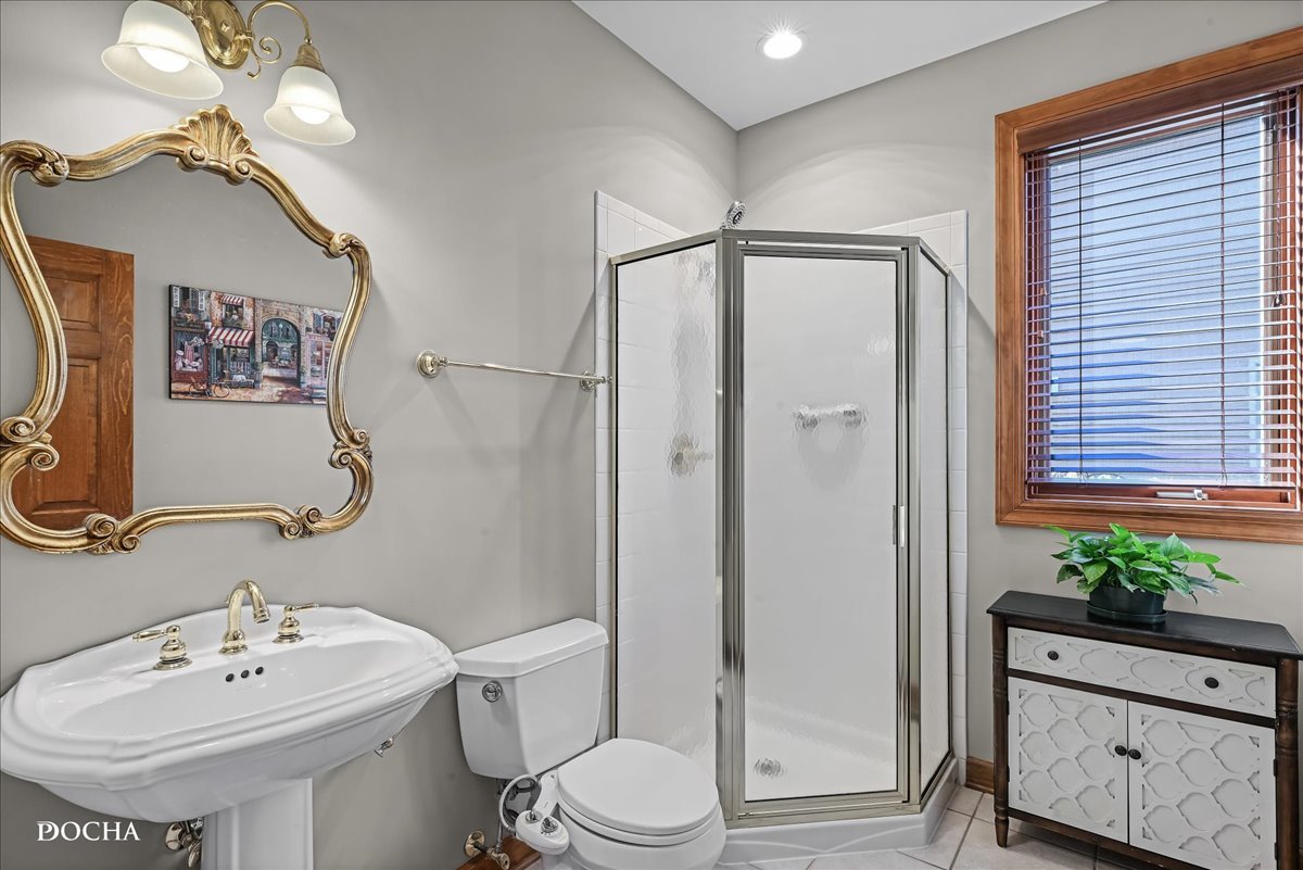 1107 Tuthill Road Naperville, IL 60563 - Photo 20 of 59 a bathroom with a sink toilet and shower