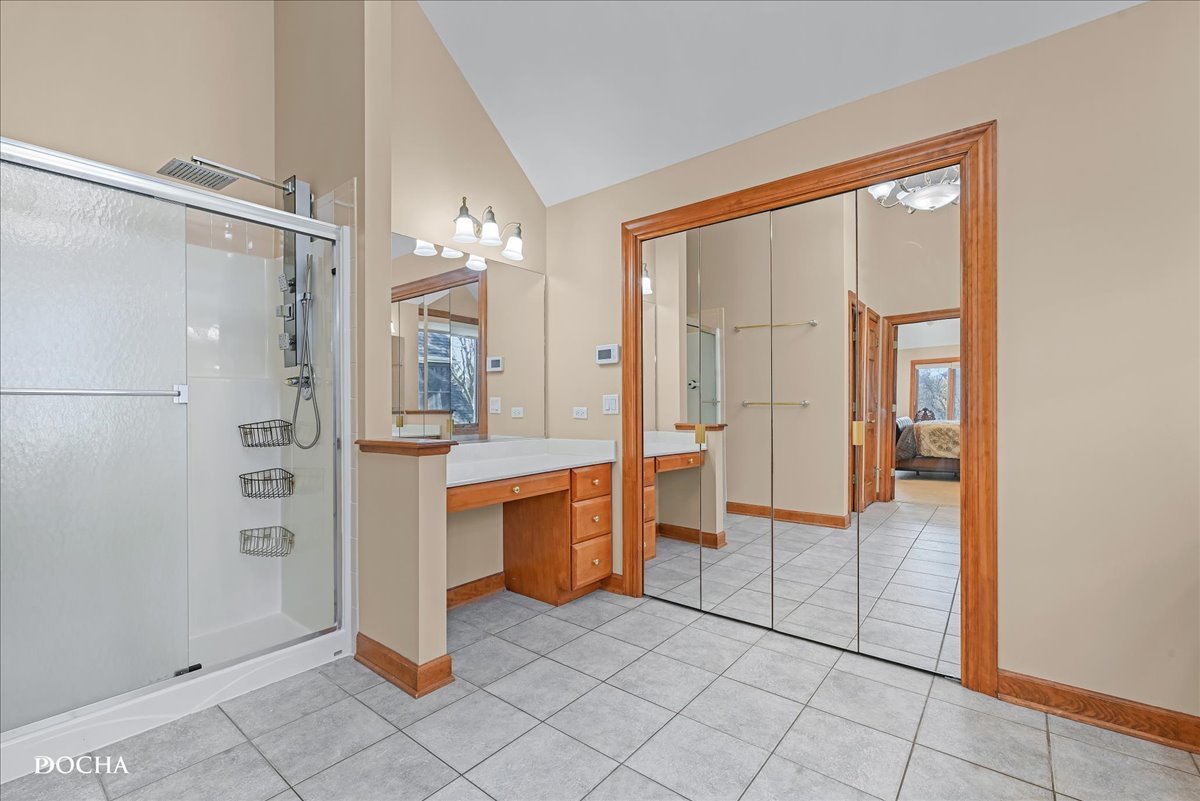 1107 Tuthill Road Naperville, IL 60563 - Photo 27 of 59 a spacious bathroom with a glass shower door and a mirror