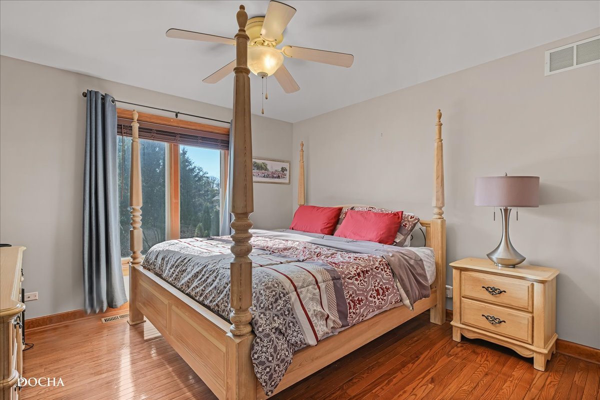 1107 Tuthill Road Naperville, IL 60563 - Photo 34 of 59 a bedroom with a bed and wooden floor