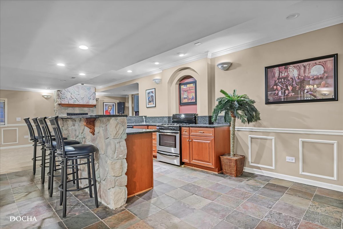 1107 Tuthill Road Naperville, IL 60563 - Photo 40 of 59 a kitchen with stainless steel appliances granite countertop a table and chairs in it