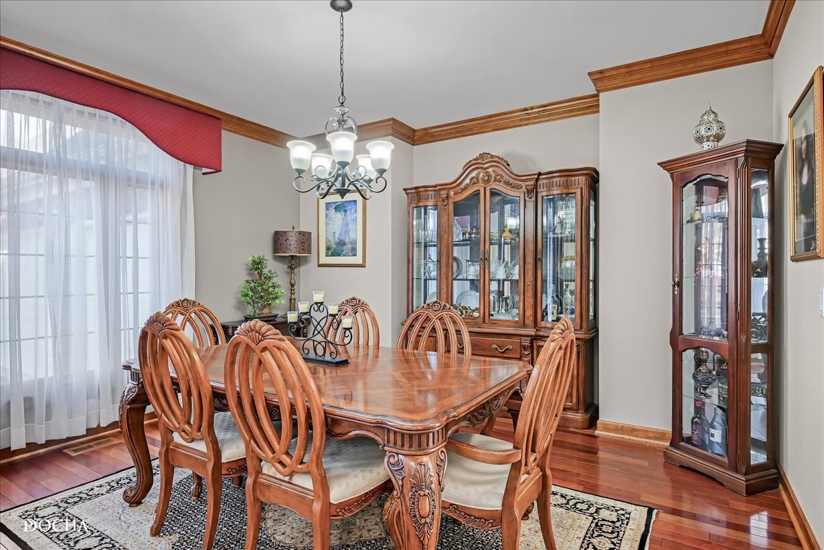 1107 Tuthill Road Naperville, IL 60563 - Photo 6 of 59 a view of a dining room with furniture wooden floor and chandelier