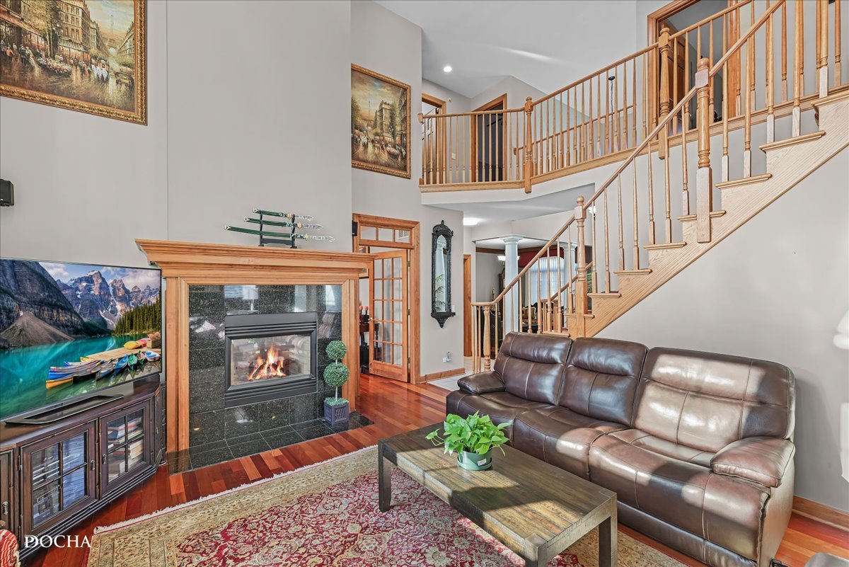 1107 Tuthill Road Naperville, IL 60563 - Photo 8 of 59 a living room with furniture a fireplace and a flat screen tv