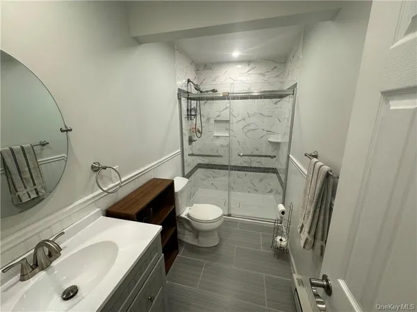 a bathroom with a sink toilet and shower