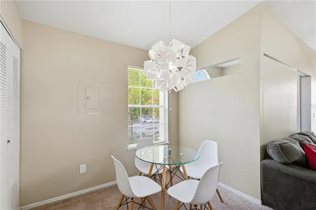 a view of a dining room with furniture and chandelier