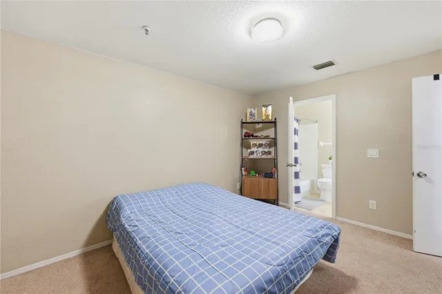 a bedroom with a bed and a bookshelf