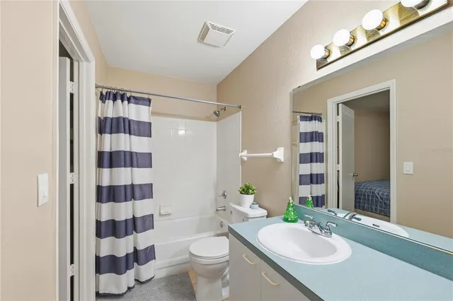 a bathroom with a sink a toilet a shower and a mirror