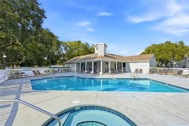 a view of swimming pool with outdoor seating and plants