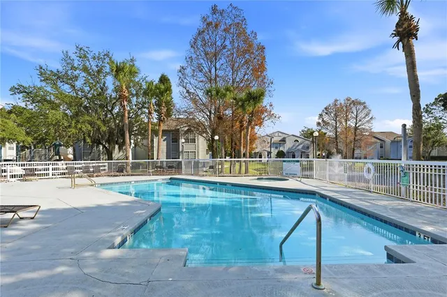 a swimming pool with outdoor seating and yard