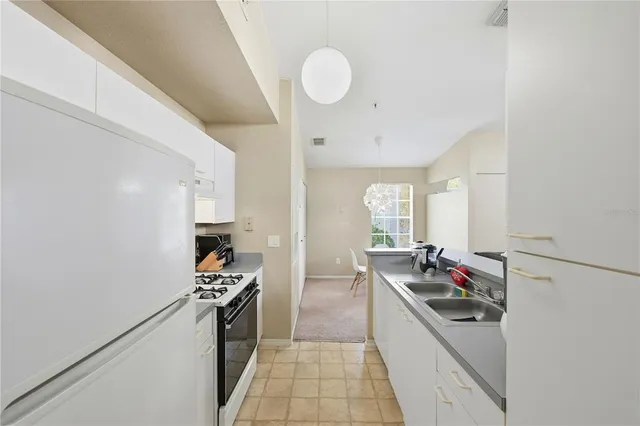 a kitchen with a stove and a refrigerator