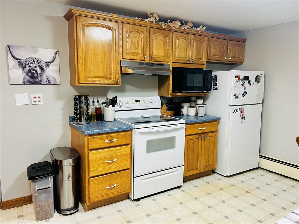 62 Arnold Road Sturbridge, MA 01518 - Photo 9 of 28 a kitchen with granite countertop a refrigerator a stove a sink and dishwasher