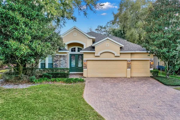 a front view of a house with a yard and garage