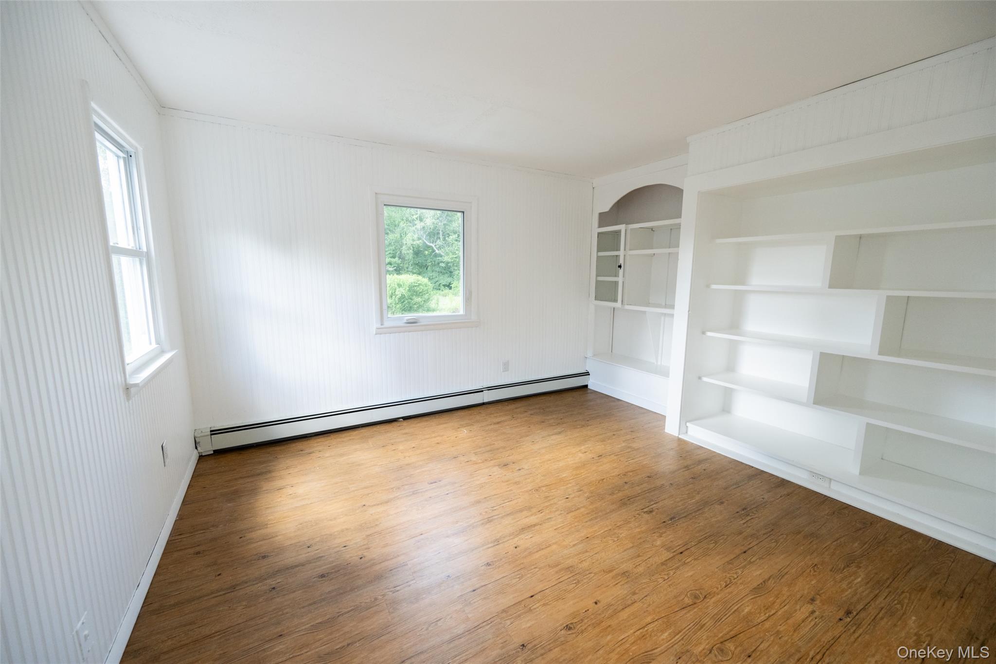 136 Foggintown Road Brewster, NY 10509 - Photo 31 of 50 an empty room with wooden floor and windows
