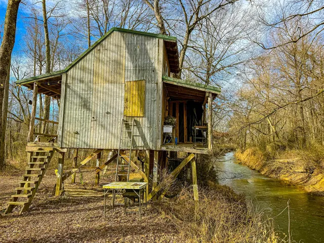 a blue bench sitting in front of a house