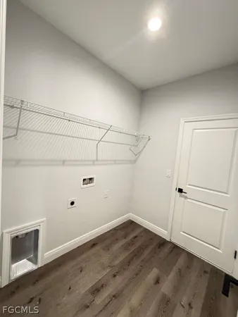 an empty room with wooden floor and cabinet