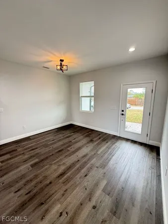 a view of a room with wooden floor and fan