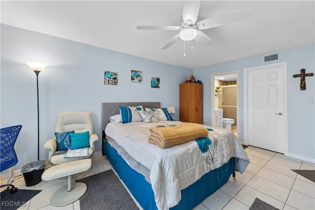 a bedroom with a bed a lamp and a chandelier