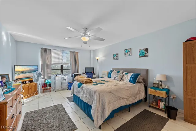 a bedroom with bed a table and a window