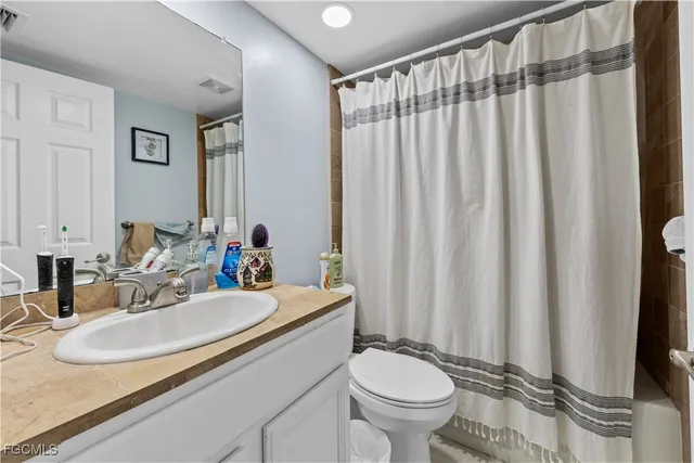 a bathroom with a sink toilet and a mirror