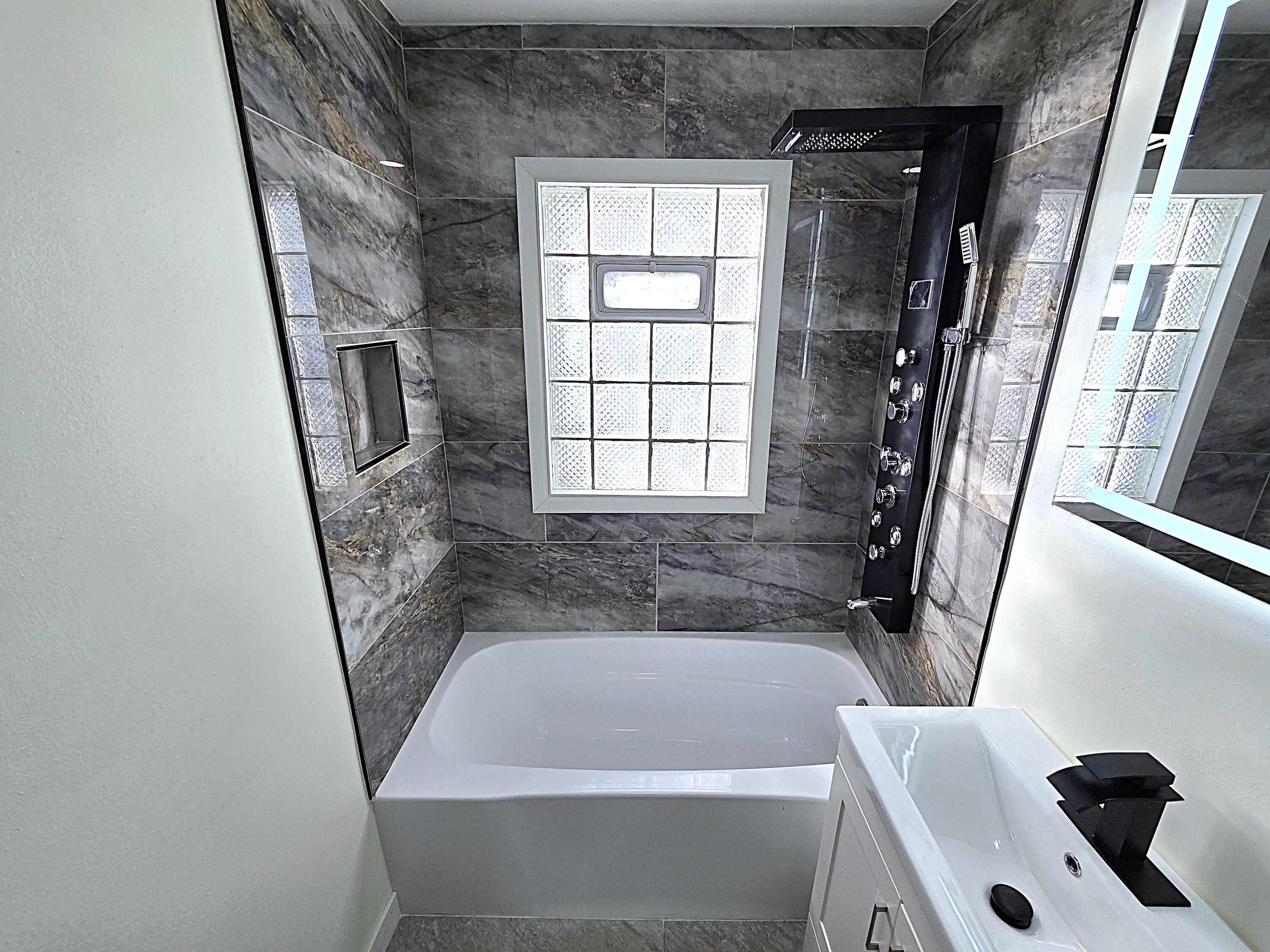 8114 West Congress Street Milwaukee, WI 53218 - Photo 18 of 39 Updated Bathroom Tiled Surround