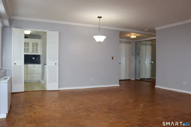 an empty room with closet and windows