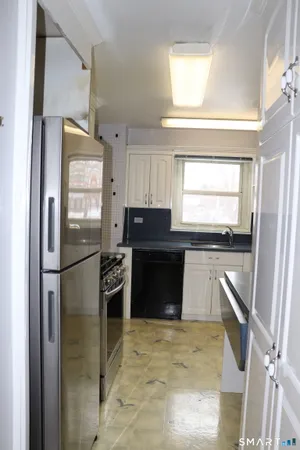 a kitchen with a refrigerator and a sink