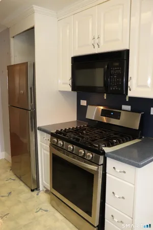 a stove top oven sitting inside of a kitchen