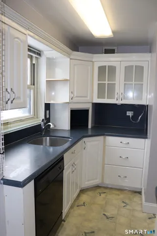 a kitchen with a sink and cabinets