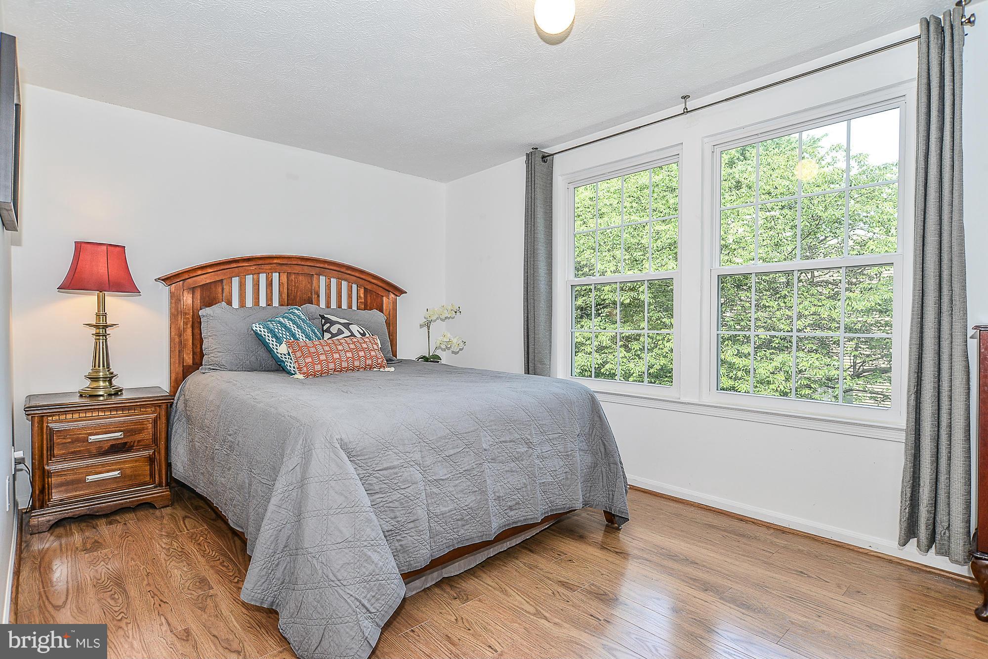 11790 Bayfield Court Reston, VA 20194 - Photo 14 of 25 a bedroom with a bed and a large window