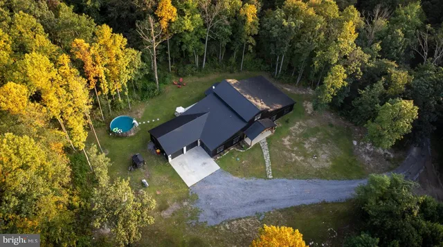 an aerial view of house with yard swimming pool and outdoor seating
