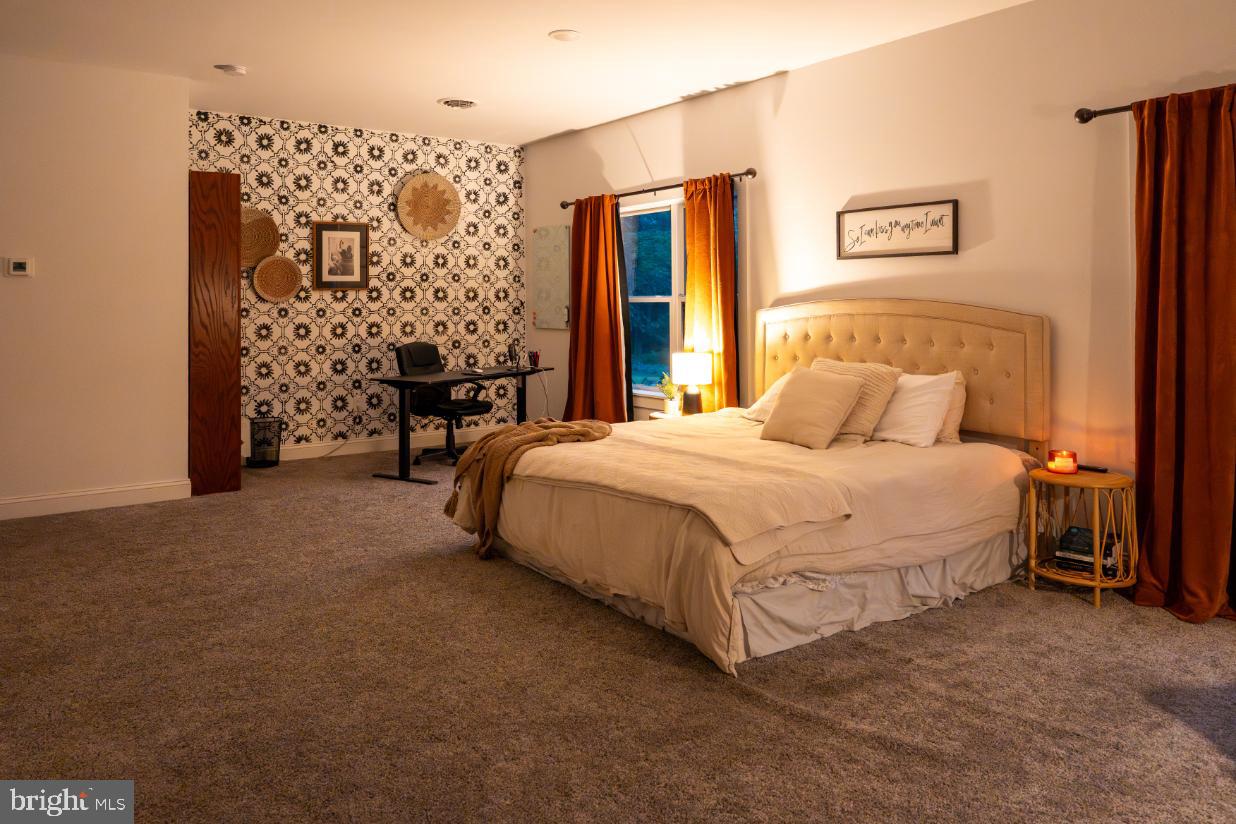 180 Gutshall Road Shippensburg, PA 17257 - Photo 10 of 37 a spacious bedroom with a bed and a table in it