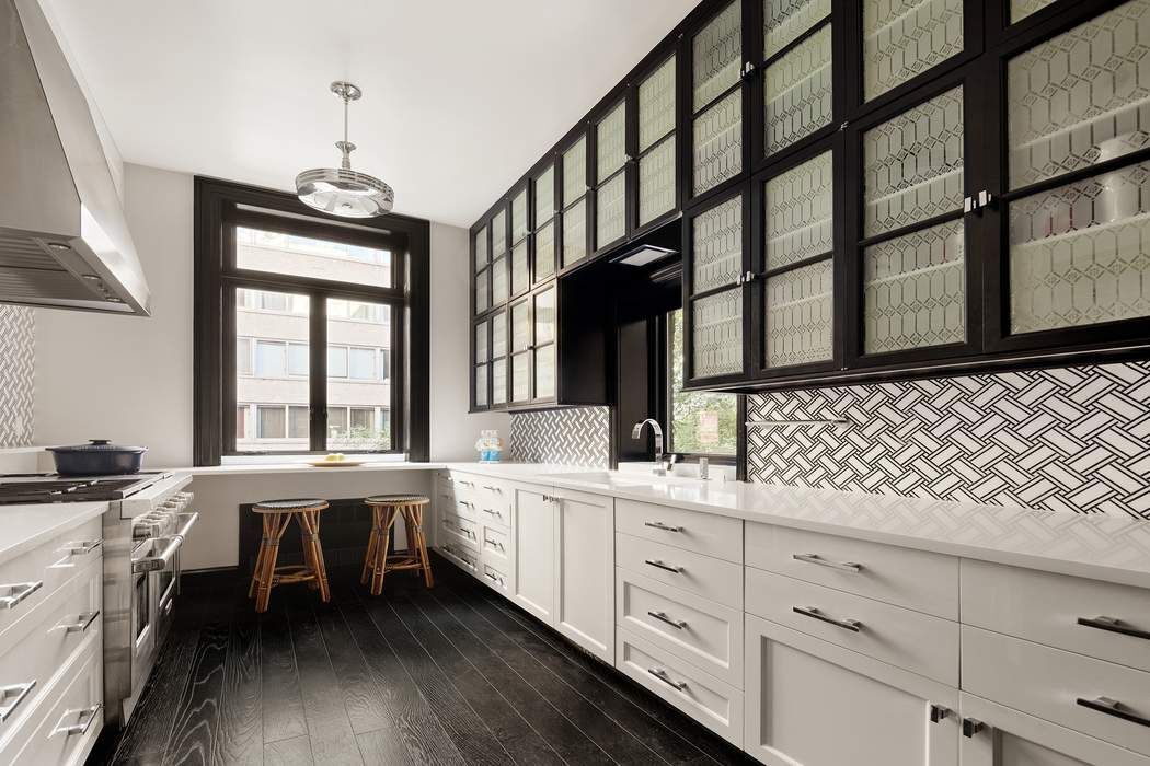 314 West 71st Street Manhattan, NY 10023 - Photo 10 of 19 a kitchen with sink cabinets and window