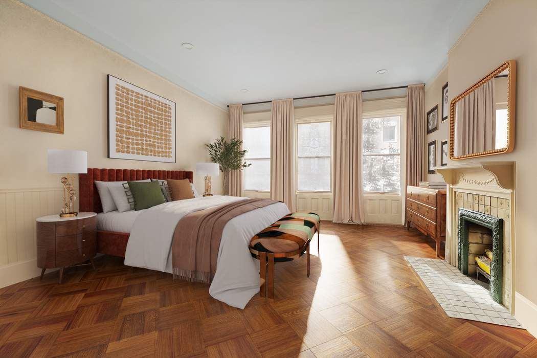 314 West 71st Street Manhattan, NY 10023 - Photo 13 of 19 a spacious bedroom with a large bed and a fireplace