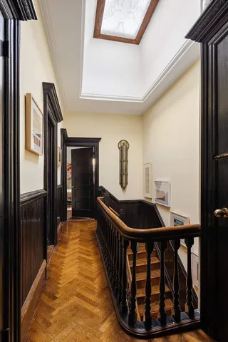 a front view of a house with barbeque oven and seating space