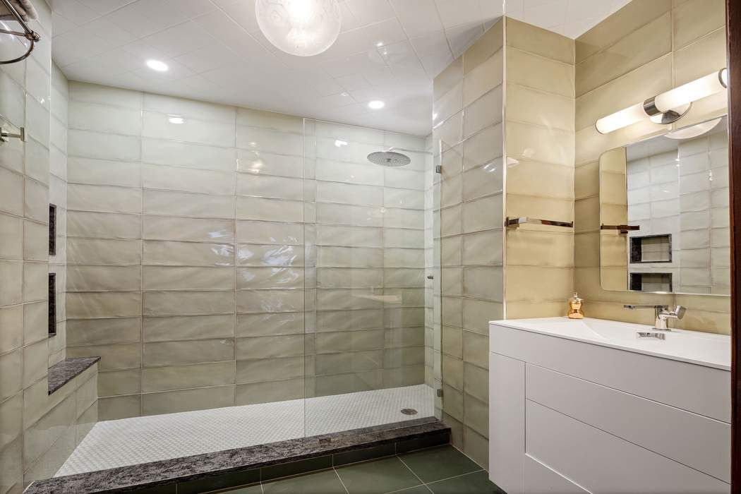 314 West 71st Street Manhattan, NY 10023 - Photo 17 of 19 a bathroom with a shower and a sink