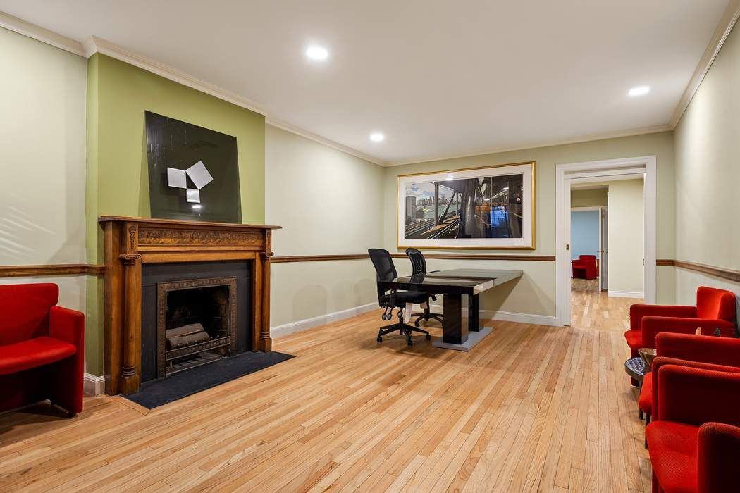 314 West 71st Street Manhattan, NY 10023 - Photo 18 of 19 a living room with furniture and a fireplace