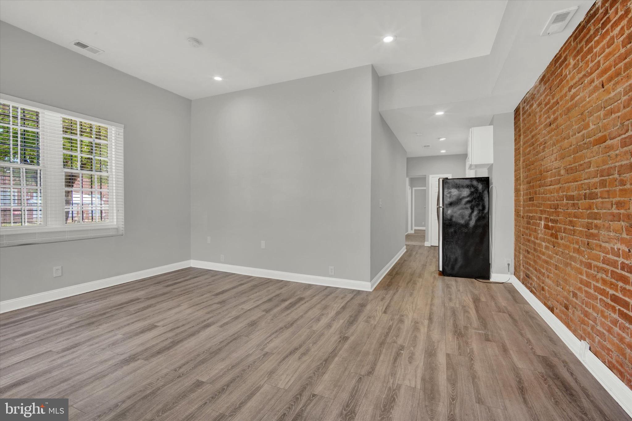 1679 Montello Avenue Northeast Washington, DC 20002 - Photo 9 of 38 wooden floor in an empty room with a window