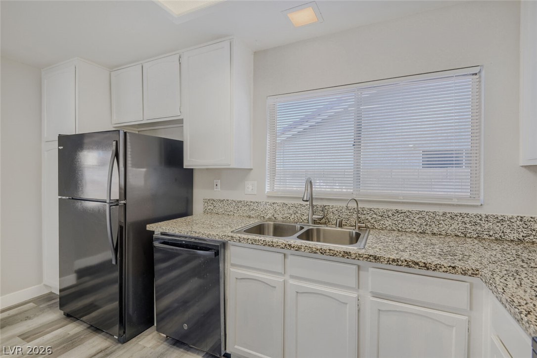 2343 Valleywood Road Henderson, NV 89014 - Photo 9 of 29 Functional kitchen with ample cabinetry and speckled countertops, perfect for daily routines.