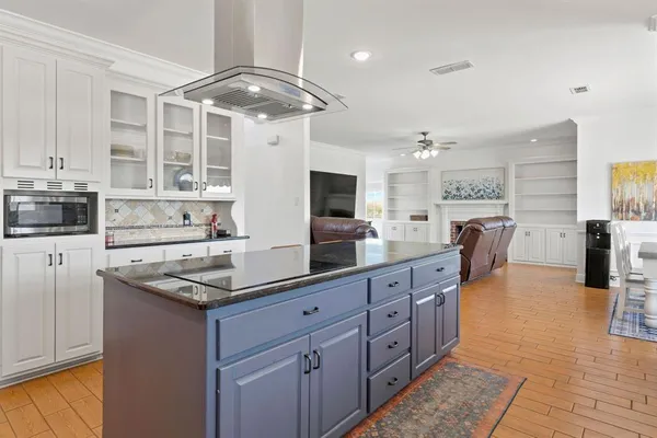 a large white kitchen with a large window