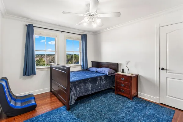 a bed sitting in a bedroom next to a window