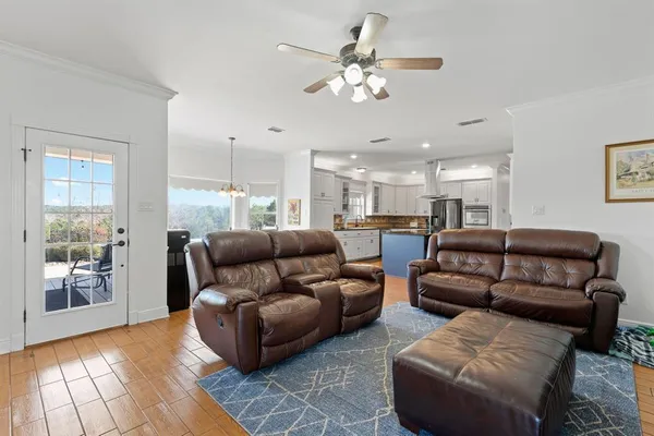 a living room with a fireplace cabinet and a rug