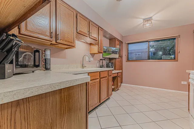 a kitchen with stainless steel appliances granite countertop a sink and cabinets