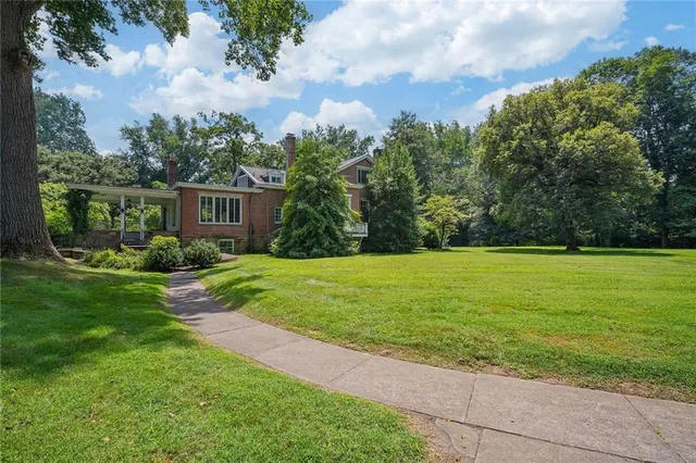 a view of backyard with swimming pool and green space